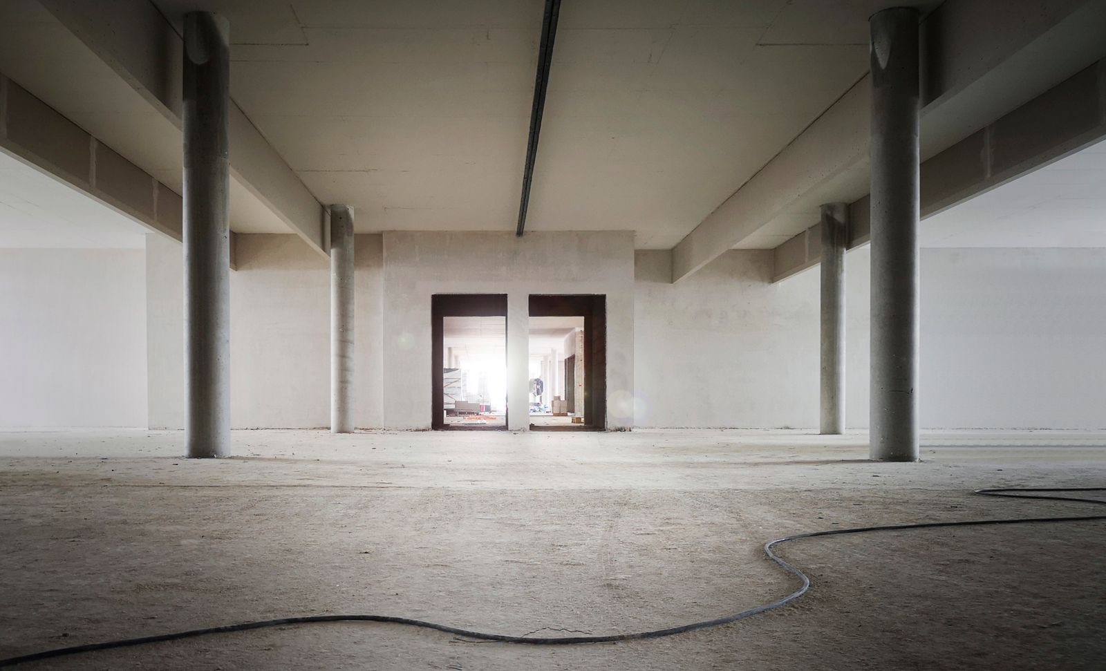 Commercial fitout in progress: bare concrete columns and unfinished shell of a commercial interior